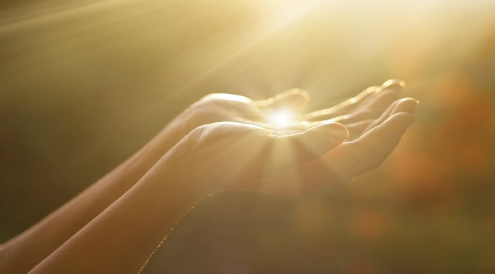 Sunlight shining on outstretced arms/hands